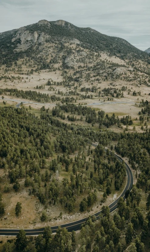 a road curves the curve in the distance between two mountains