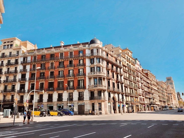 a large building sitting on the corner next to a road