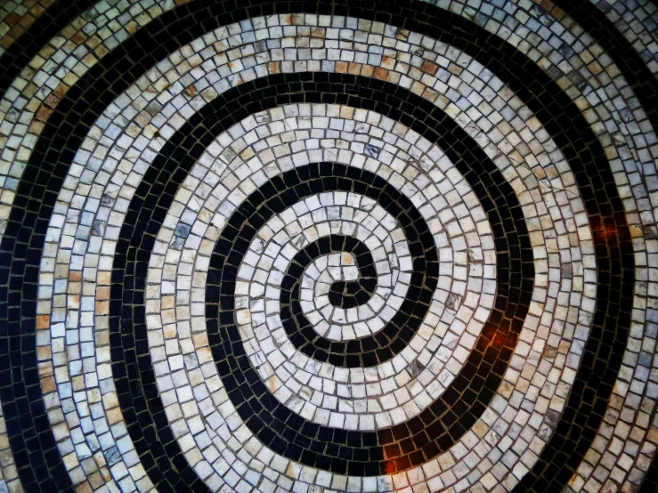 a spiral design on top of a stone tile floor