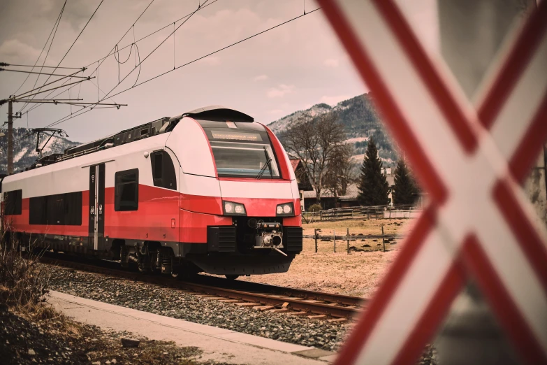 a red and white train on some train tracks