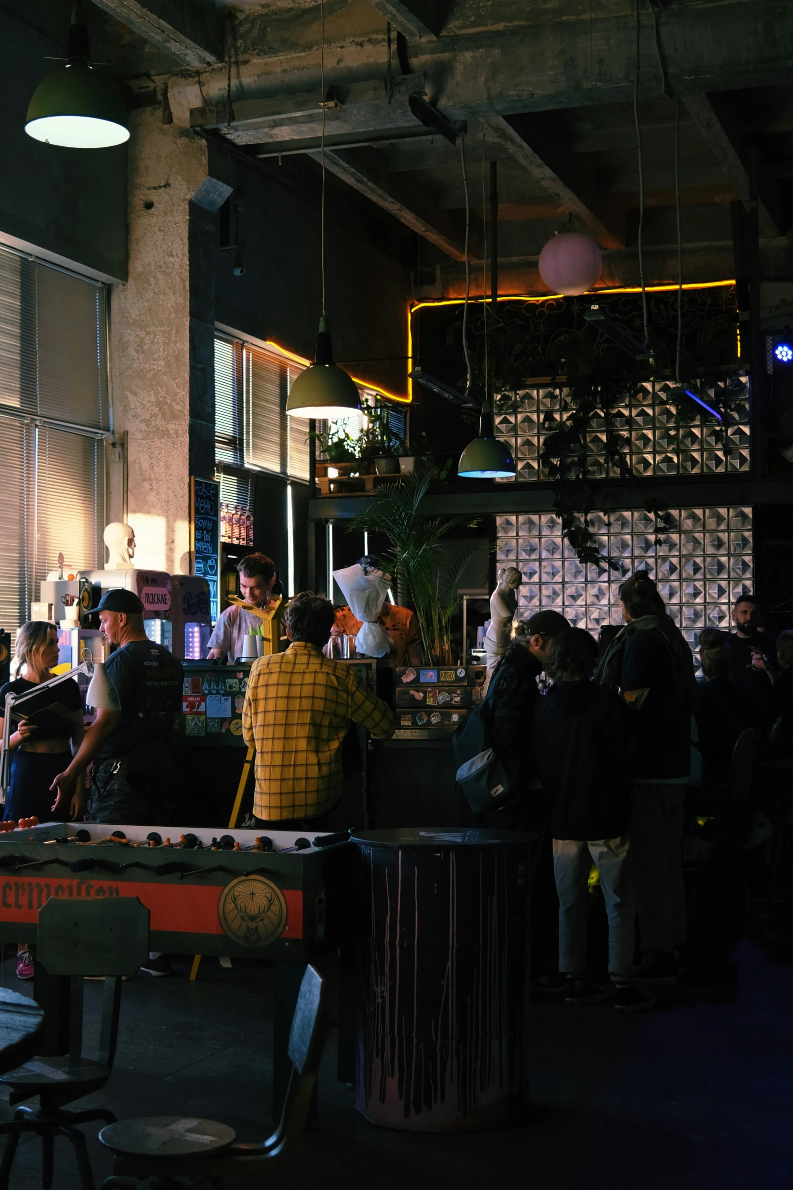 people are waiting in a room with a pool table