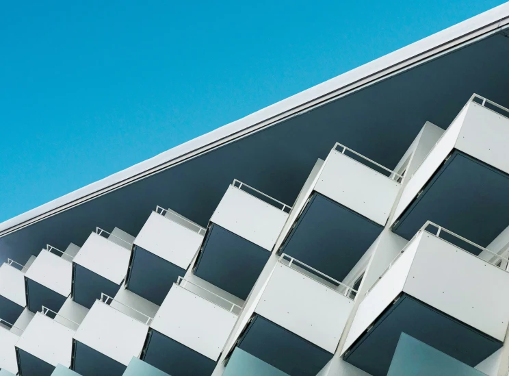 architectural s of the top of a building with a bright blue sky in the background