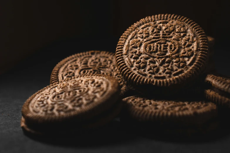 four cookies on a dark surface, stacked together