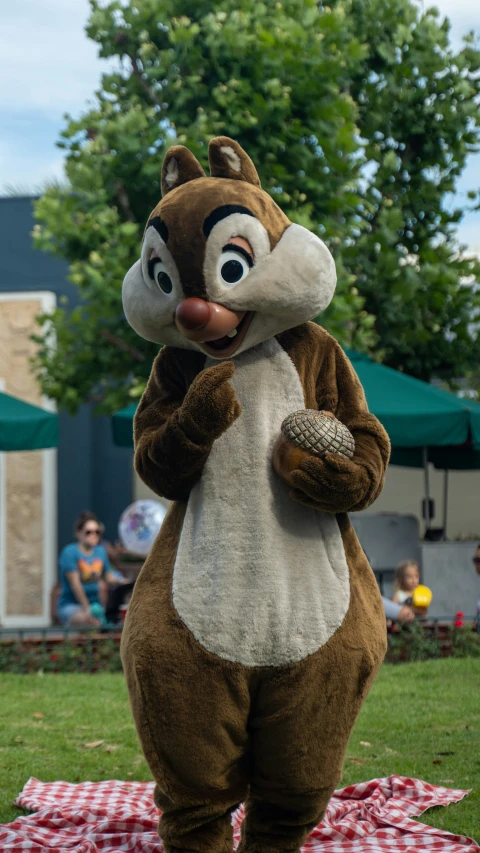 brown chipmun standing on the ground eating food