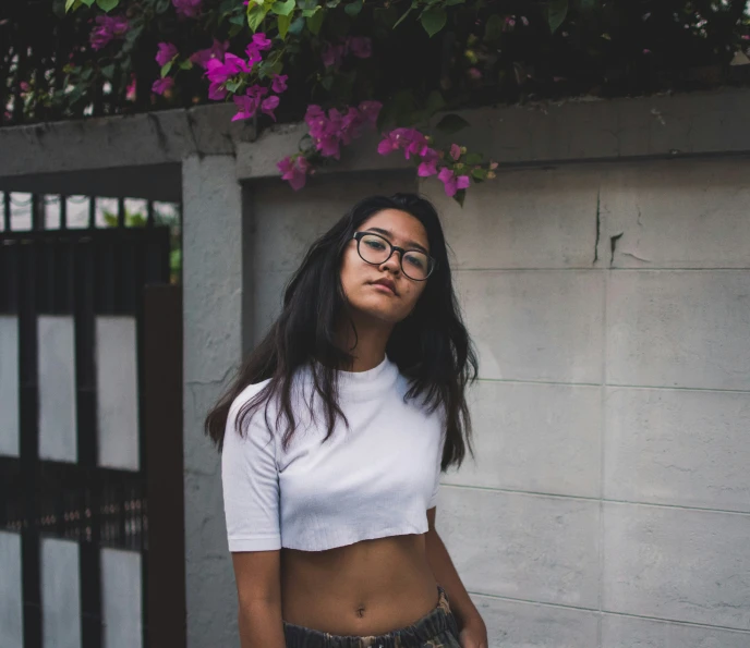 a woman wearing a crop top and plaid pants