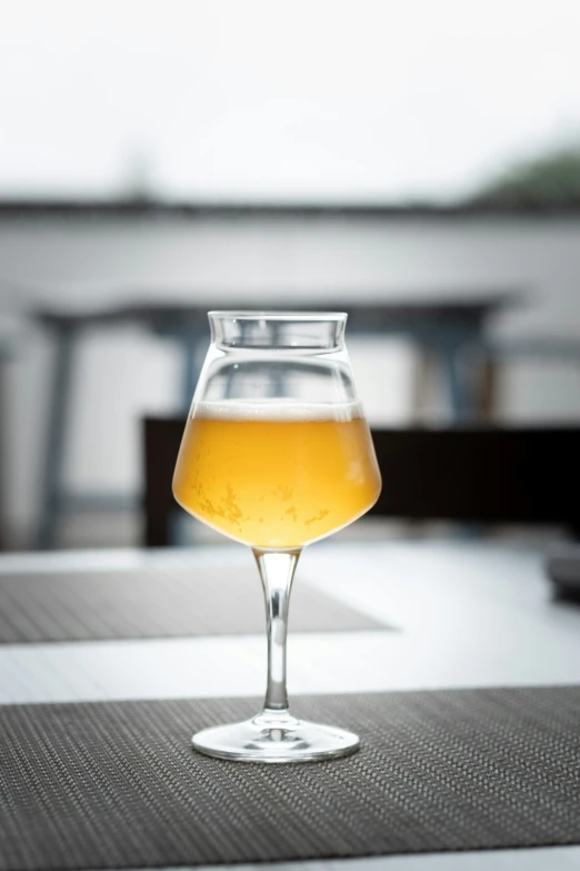 a table with a glass and some beverage on top