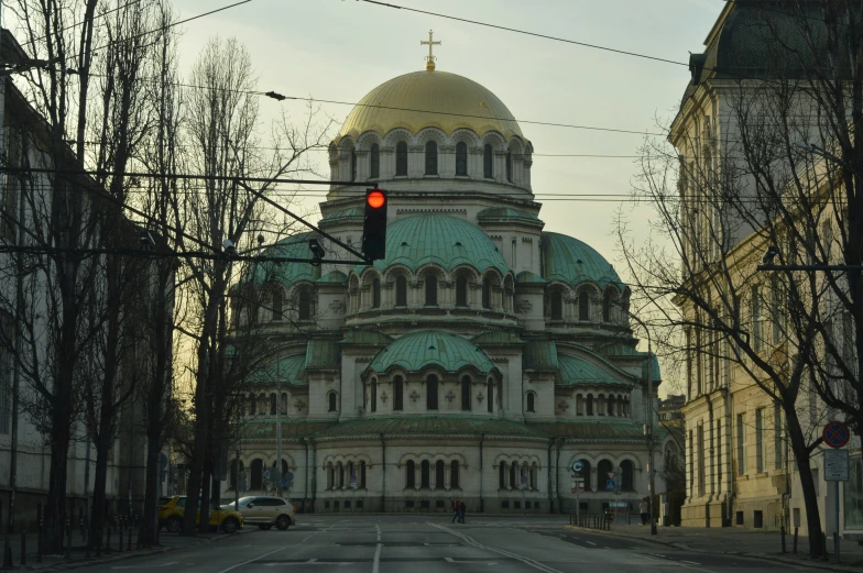 an old building sits on the corner of a road