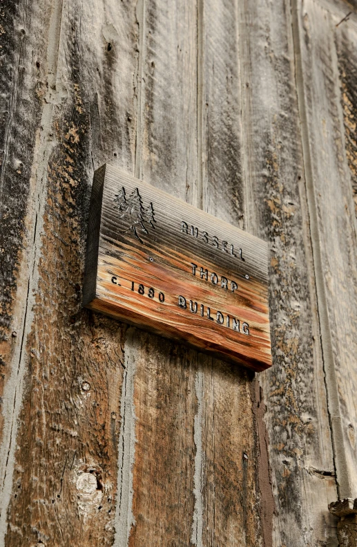a sign on the side of a wooden building