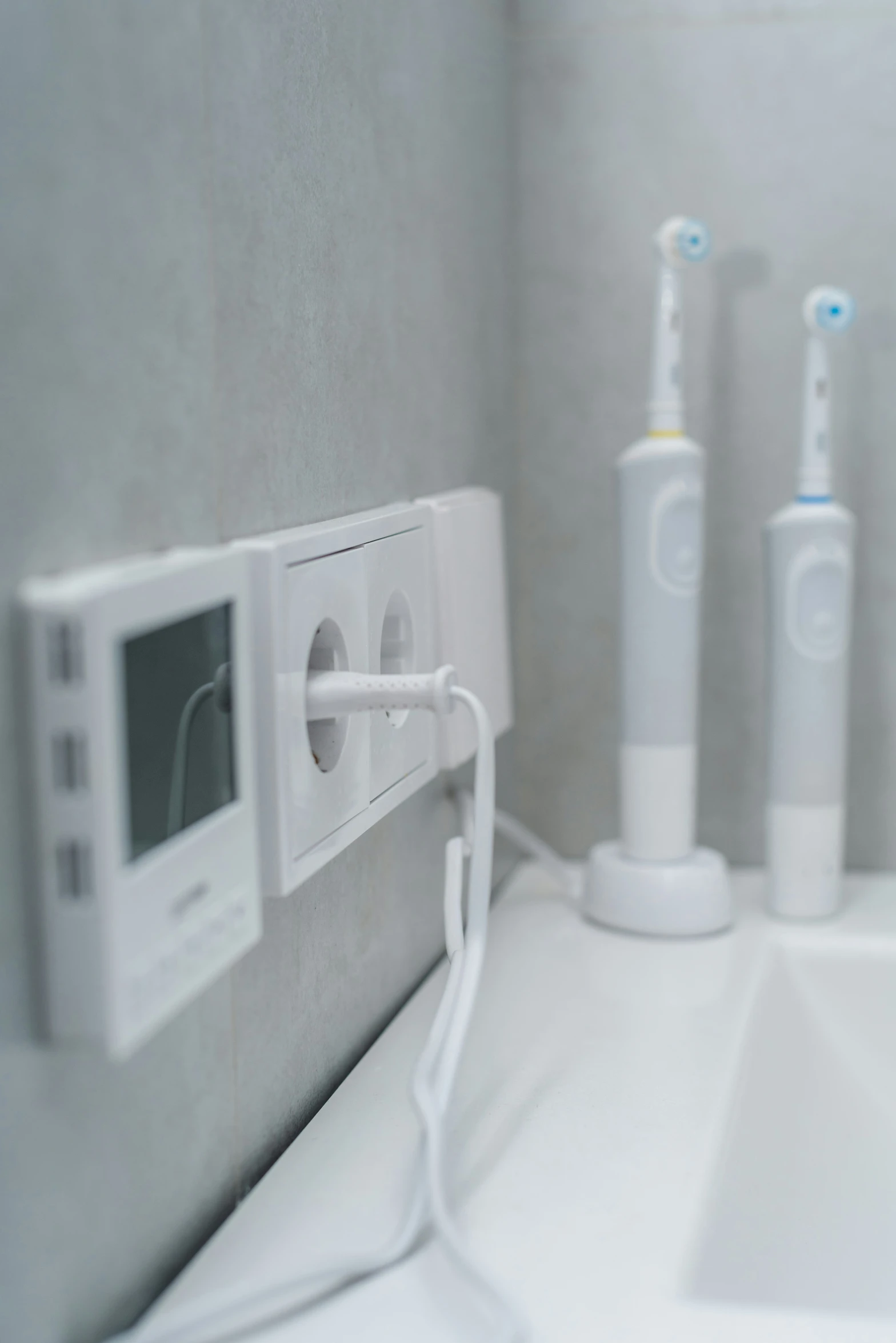 an electric toothbrush and three electric toothbrushes