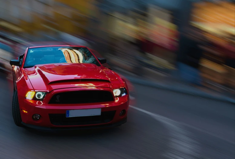 a close up of the front end of a red car