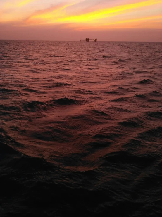 a boat out in the ocean with some people in it