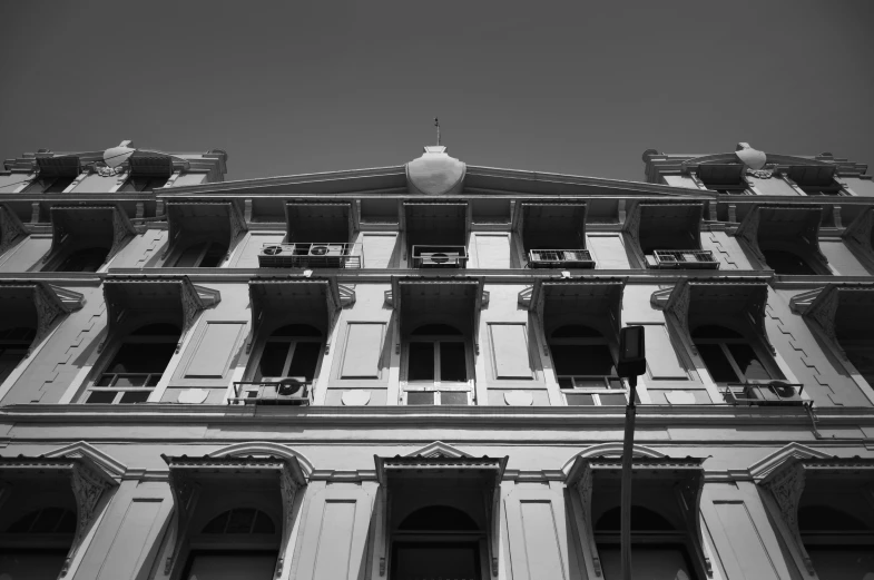 a large building with many balconies and a clock on the front