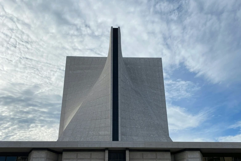 the top of a building has a large triangle shaped window