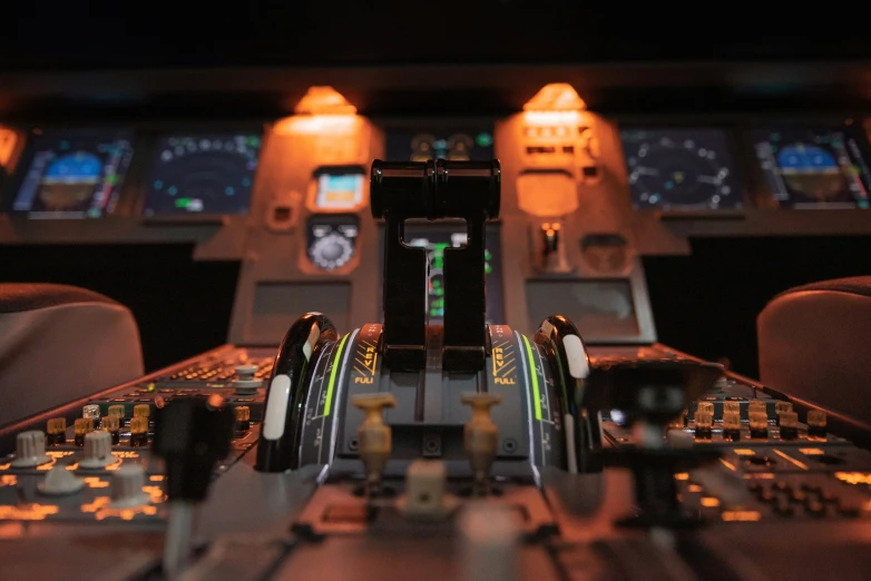 an airplane cockpit with many controls and a number of screens