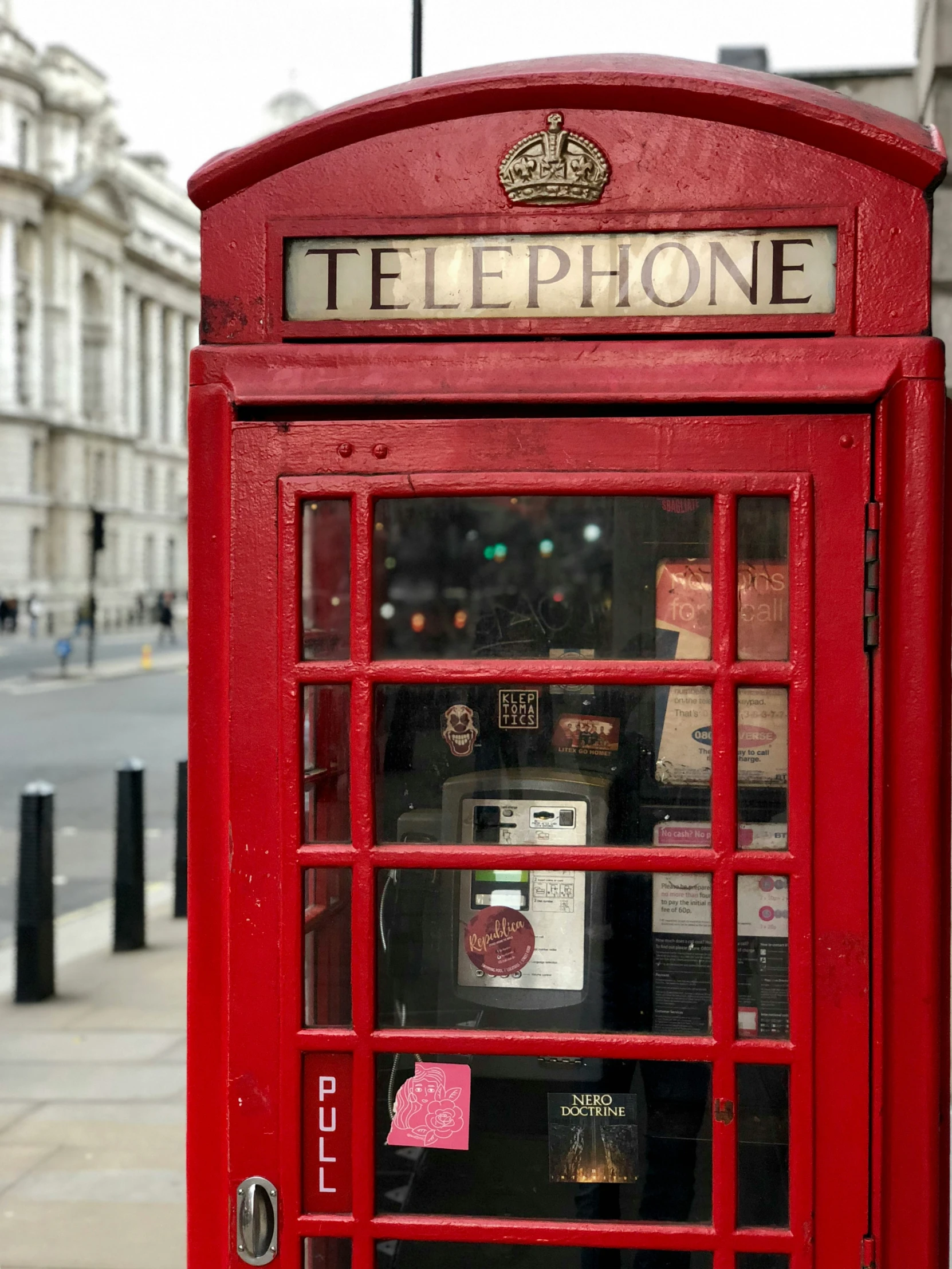 a telephone booth sitting next to a street