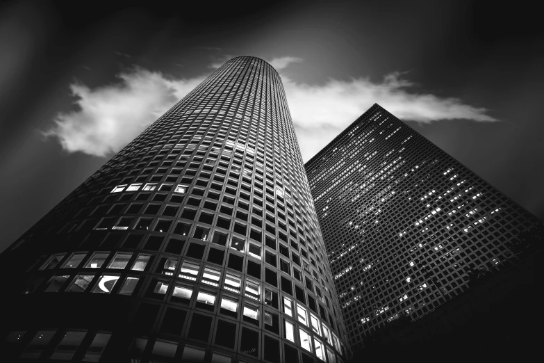 two tall building are sitting under some clouds