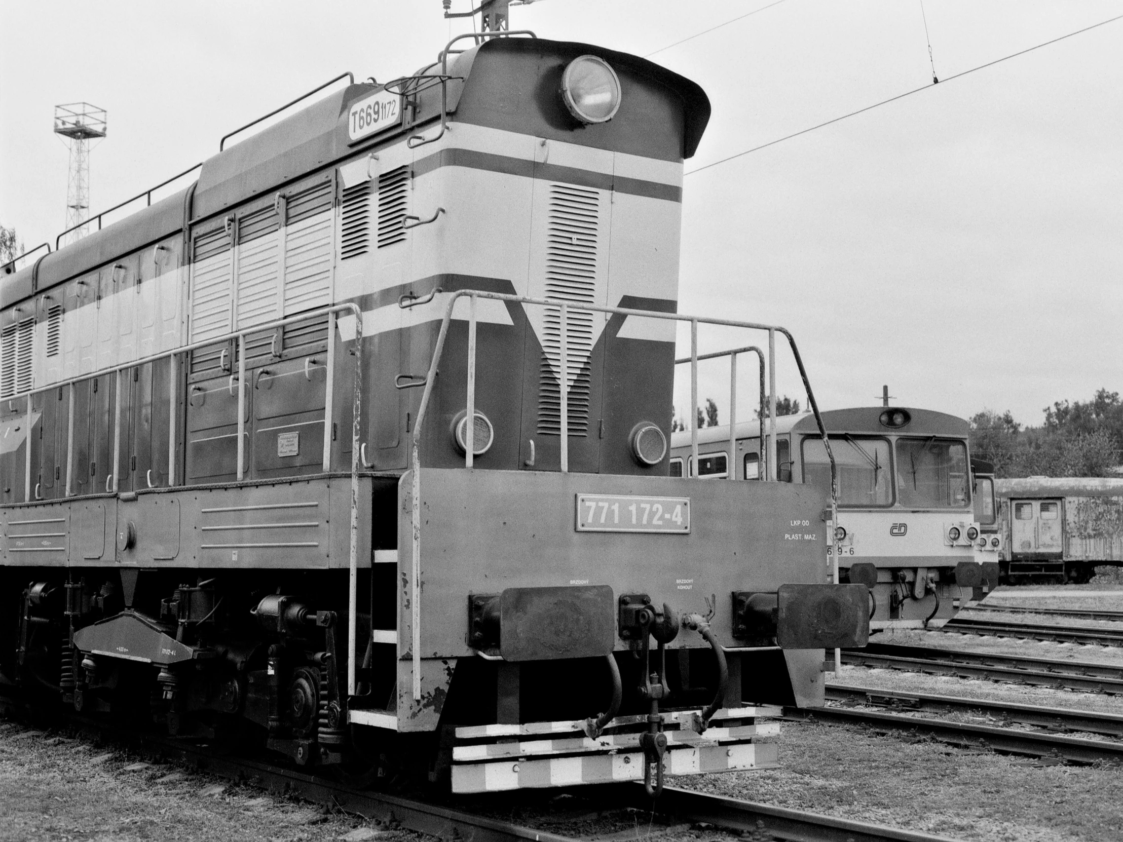 a black and white image of a train on railroad tracks
