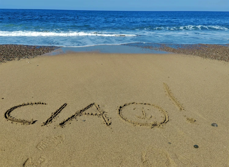 an inscription that is in the sand on a beach