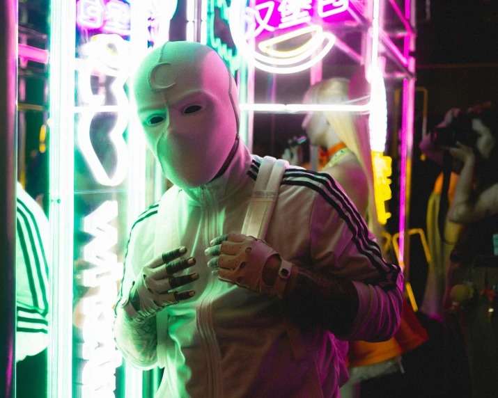 person standing in front of neon lights in costume