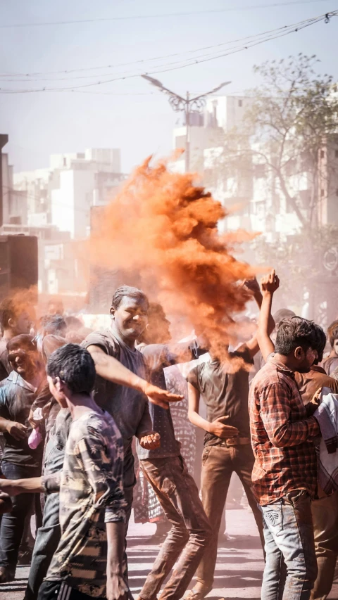 a crowd of men standing around and burning colored balls