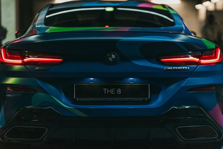 a colorful bmw car that is in front of a building