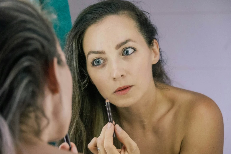 a  woman looking at her own reflection in a mirror