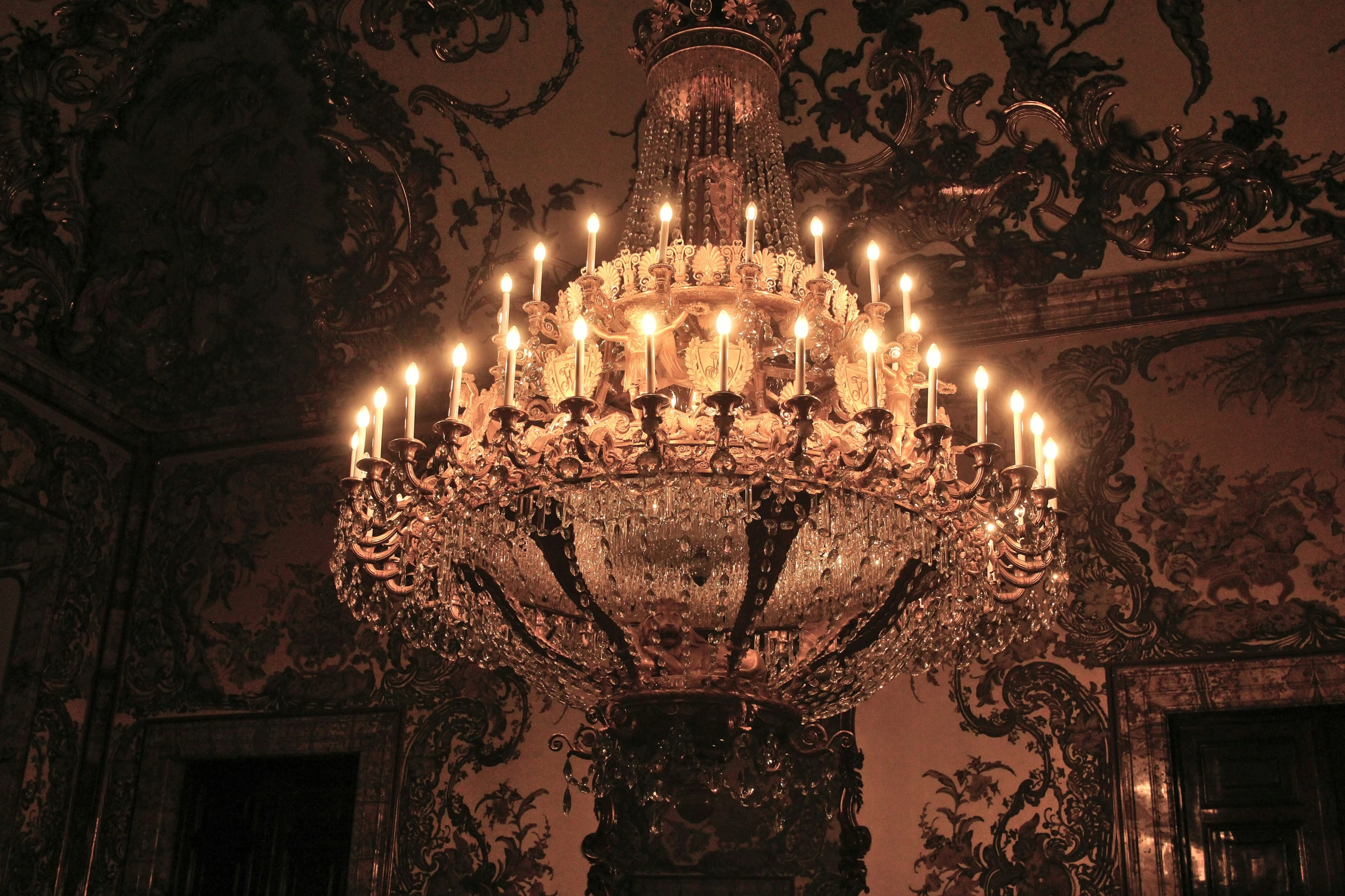 the chandelier is being used as a light in a living room