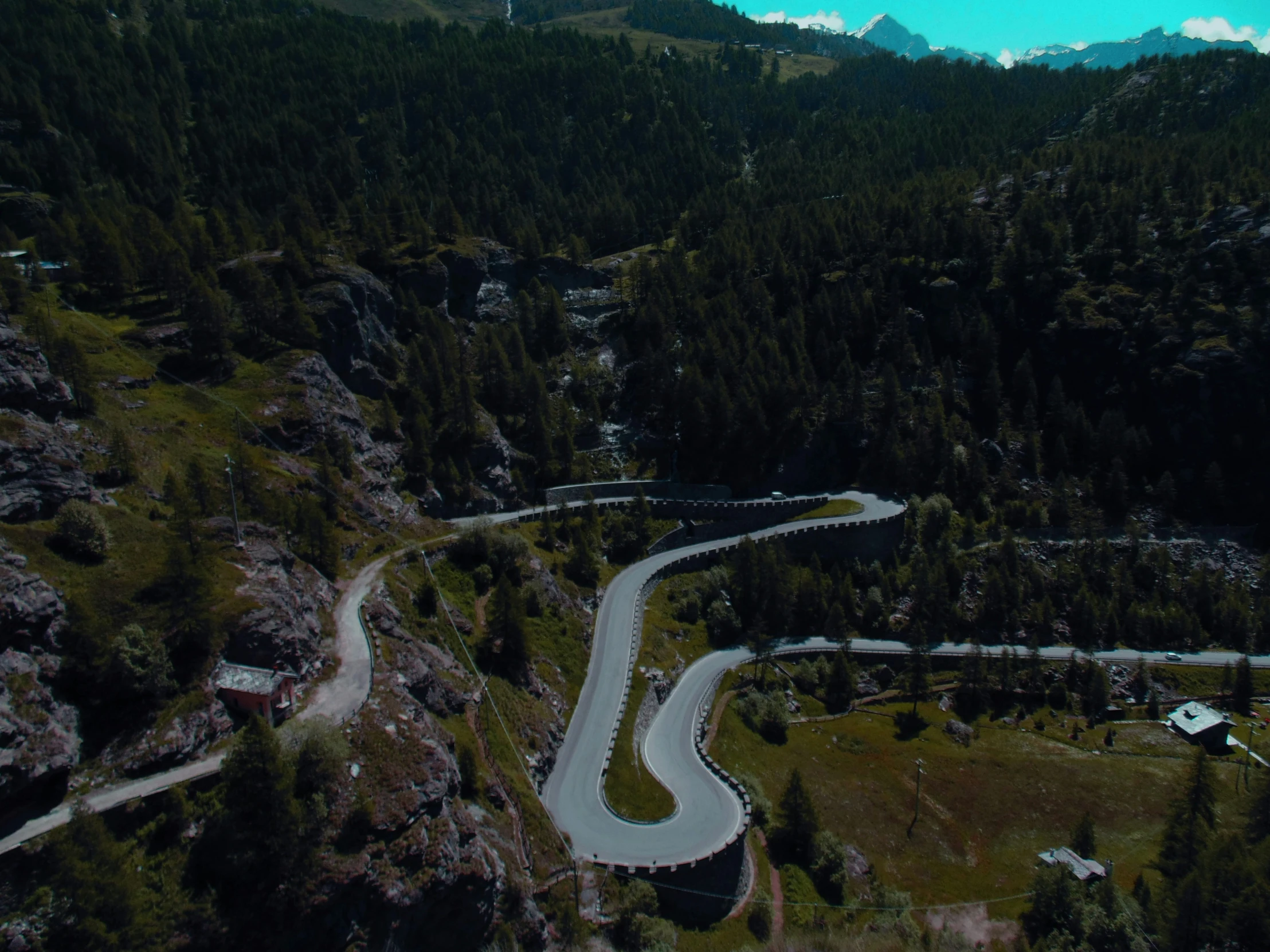 an aerial view of the road and mountains