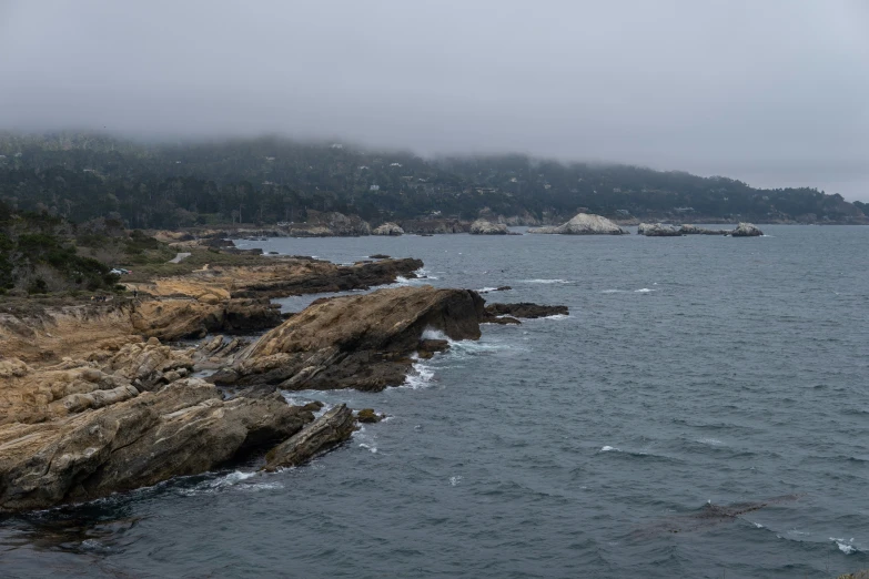 an island is sitting on the coast during the day