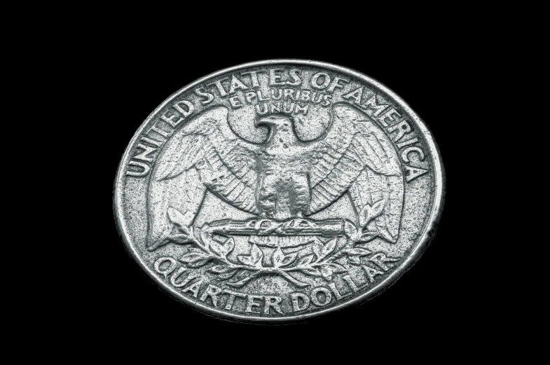 a metal coin with an eagle and motto on it