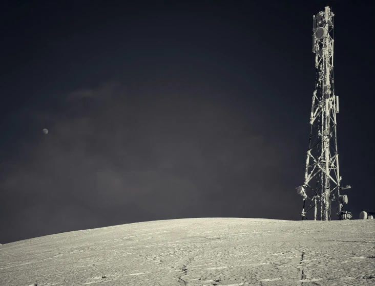 a tall tower in the middle of a snowy field