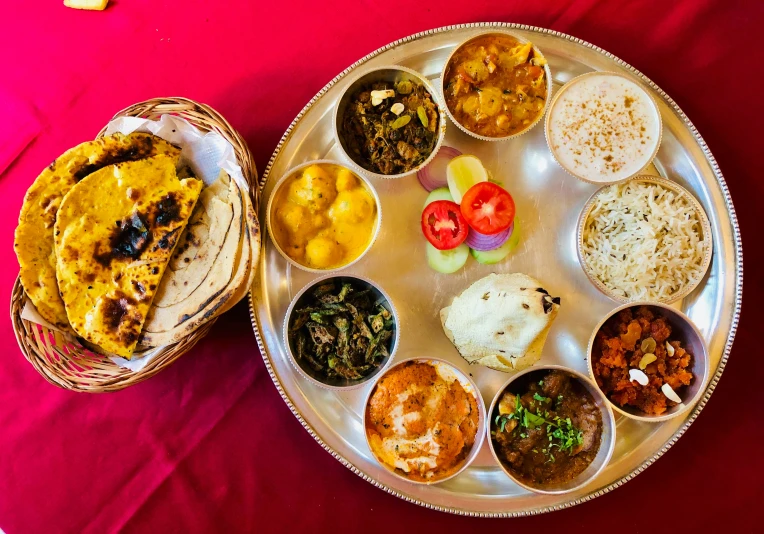 a plate of various food and a basket with rice