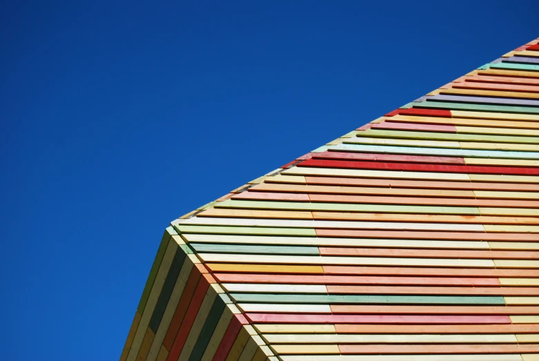 the multicolored building has a clock at the top