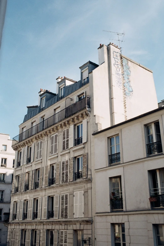 a tall white building sitting in the middle of a street