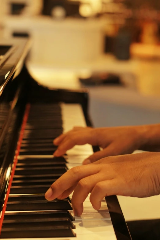 someone's hands on top of a piano keyboard