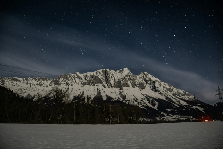 the mountain has snow on top at night time