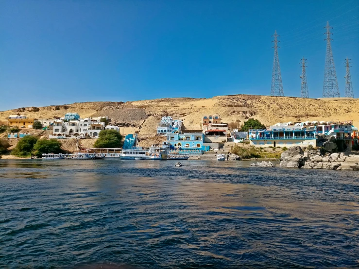 a group of houses sits in the middle of a large body of water