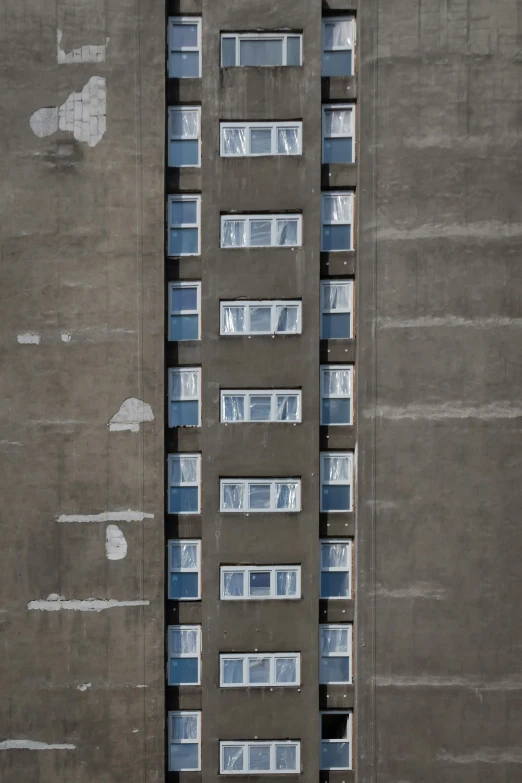 a high rise building that has glass windows on each side