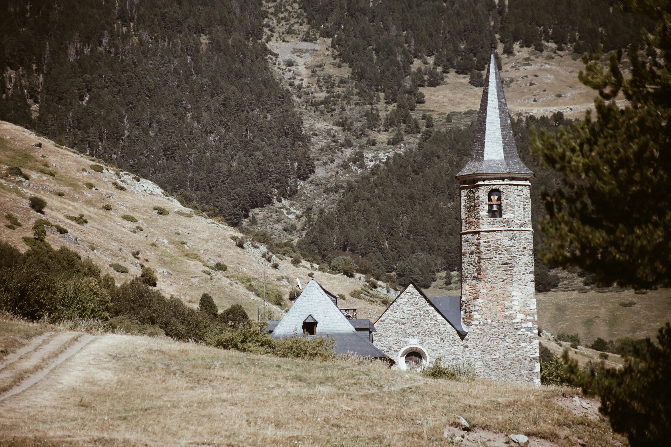 an old church sits on a hill