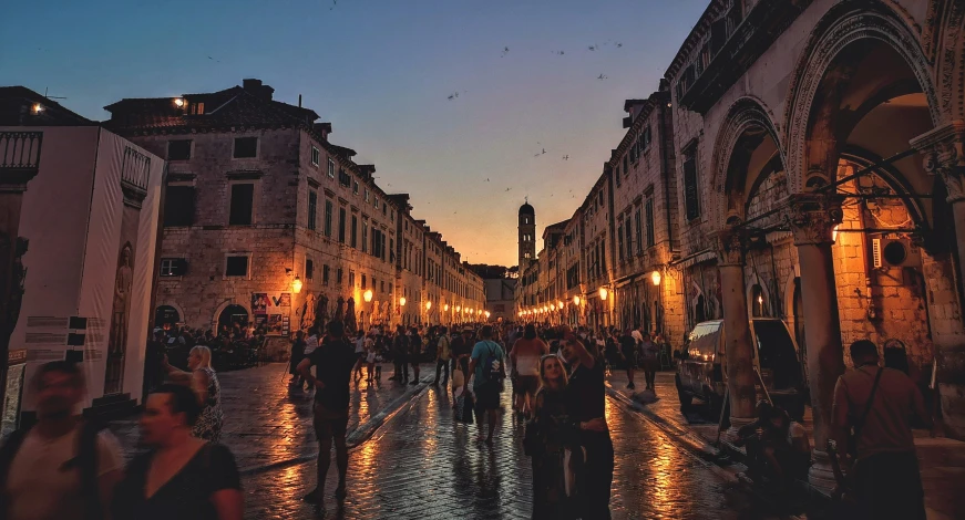 a city street with many people walking by it