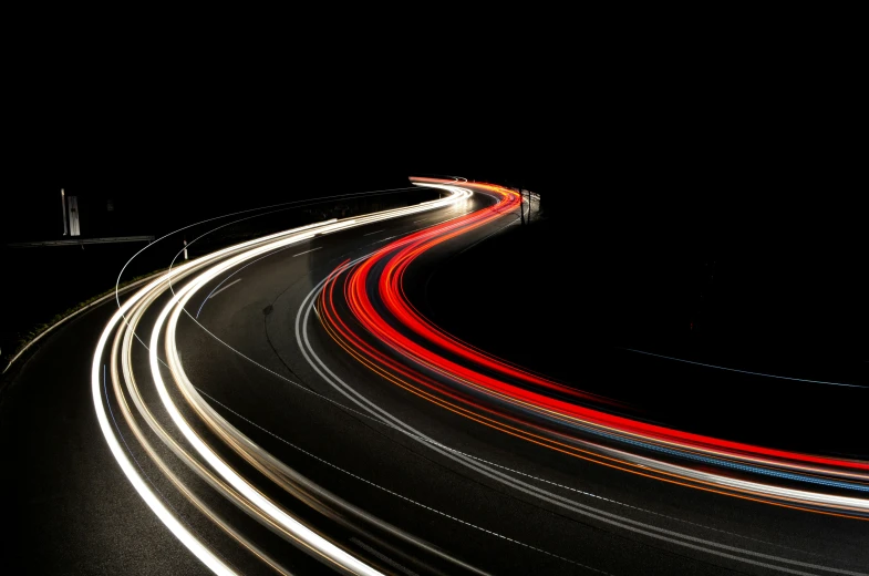 a traffic filled highway at night with a long exposure