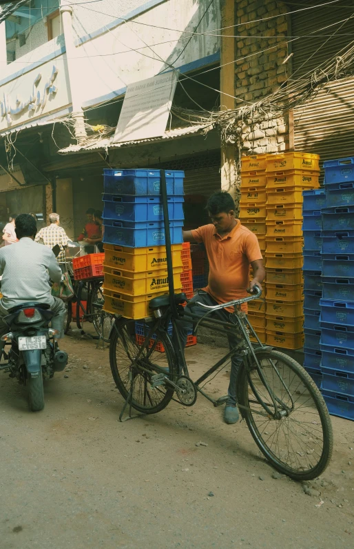 a man on a bicycle next to a large box