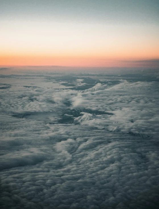 some clouds are flying above by the sky