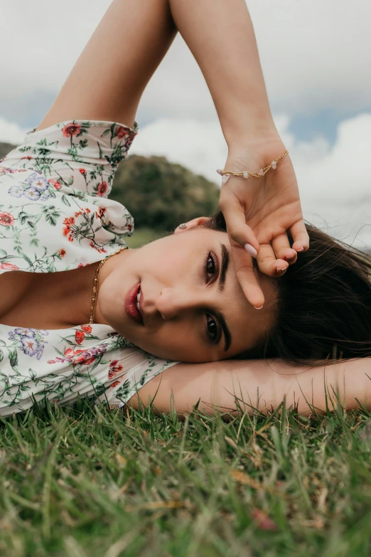 a young woman laying in the grass