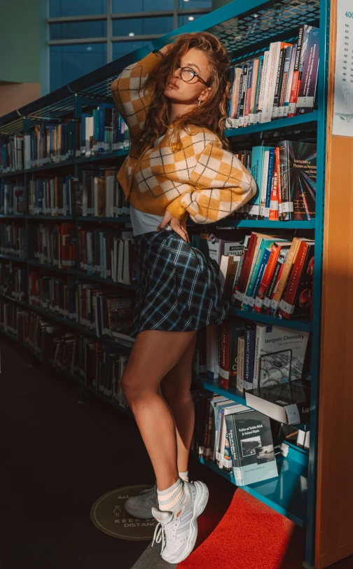 a woman standing in a liry next to a bookshelf