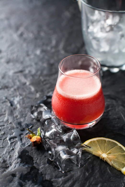 a beverage glass filled with drink on top of a table