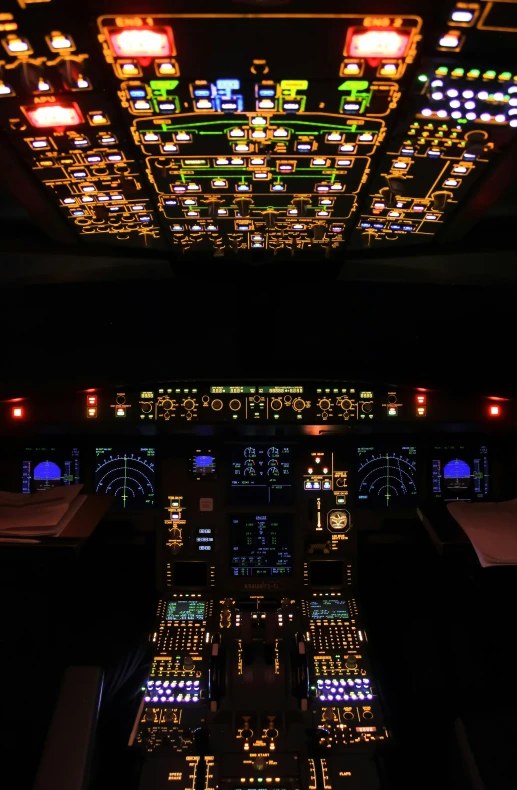 a lit cockpit of a plane illuminated in a dark room