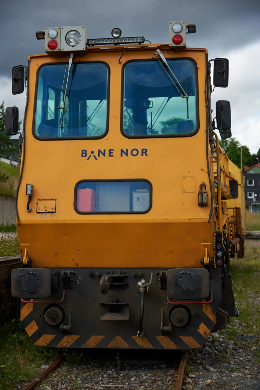 a train with an orange caboose on some tracks