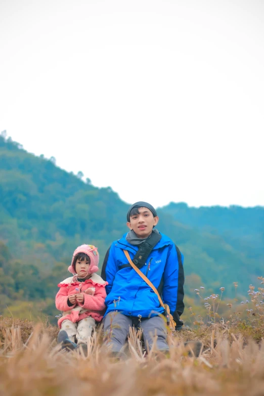 a couple of s sitting on top of a grass field