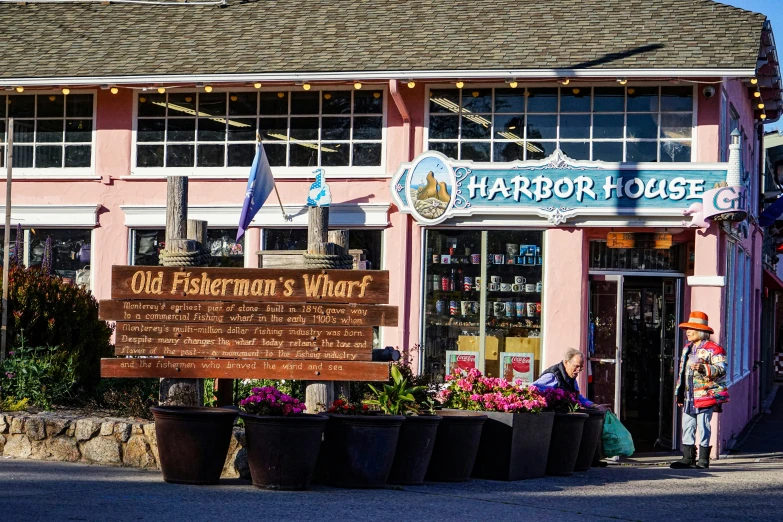 an old pink building with a sign saying harbor lodge